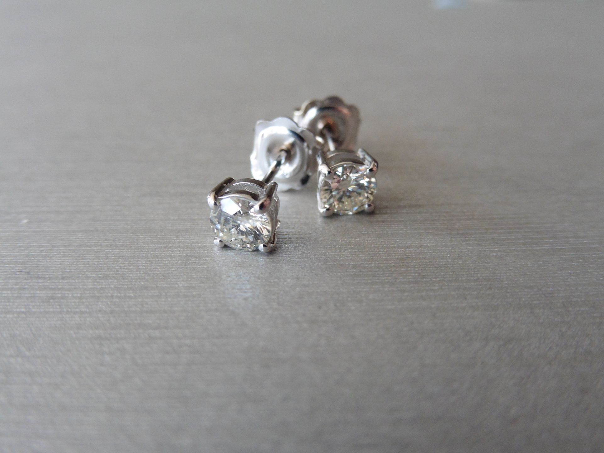 0.90ct Solitaire diamond stud earrings set with brilliant cut diamonds. SI3 clarity and H/I
