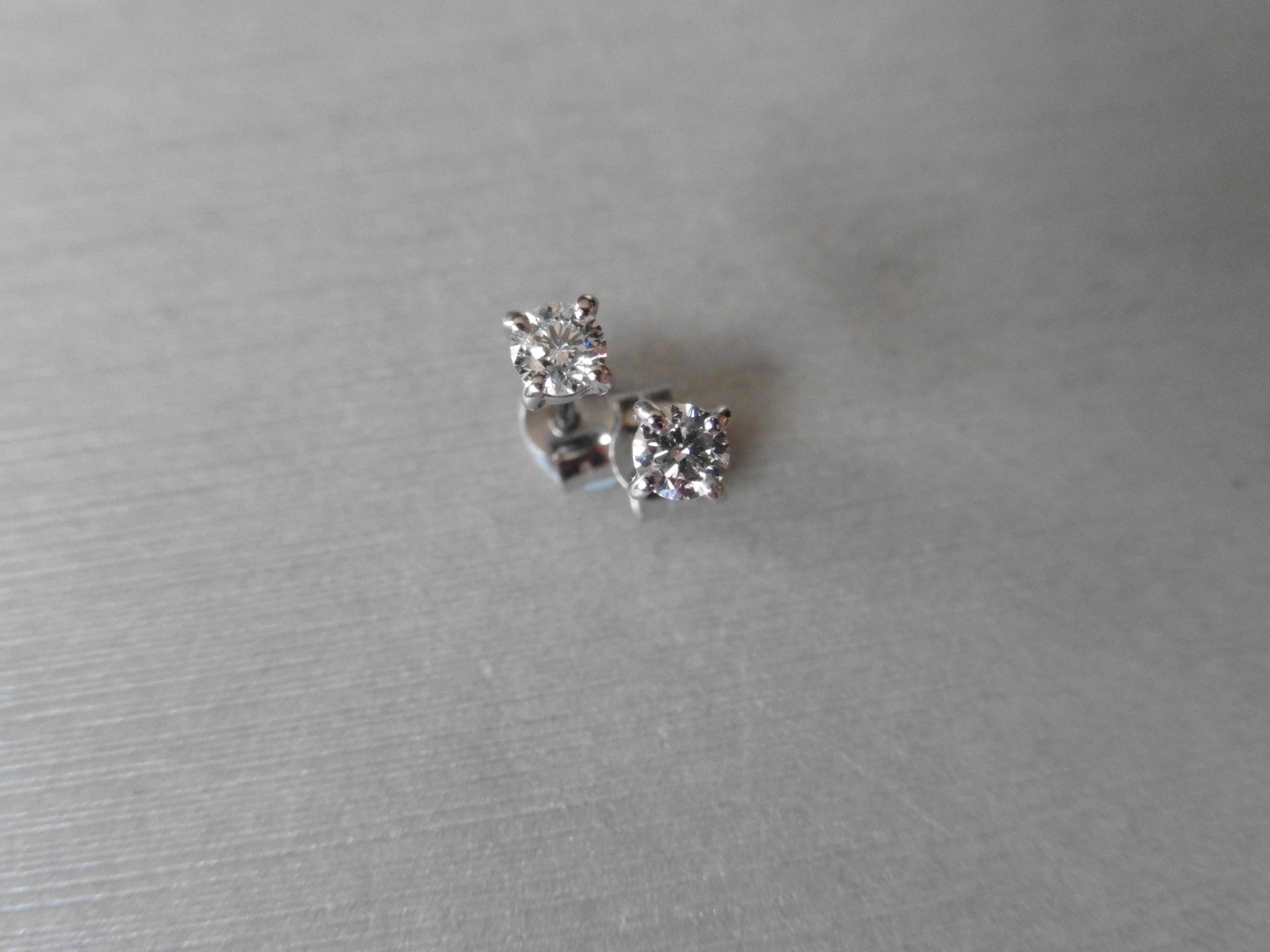 0.30ct Solitaire diamond stud earrings set with brilliant cut diamonds, SI3 clarity and H/I colour .