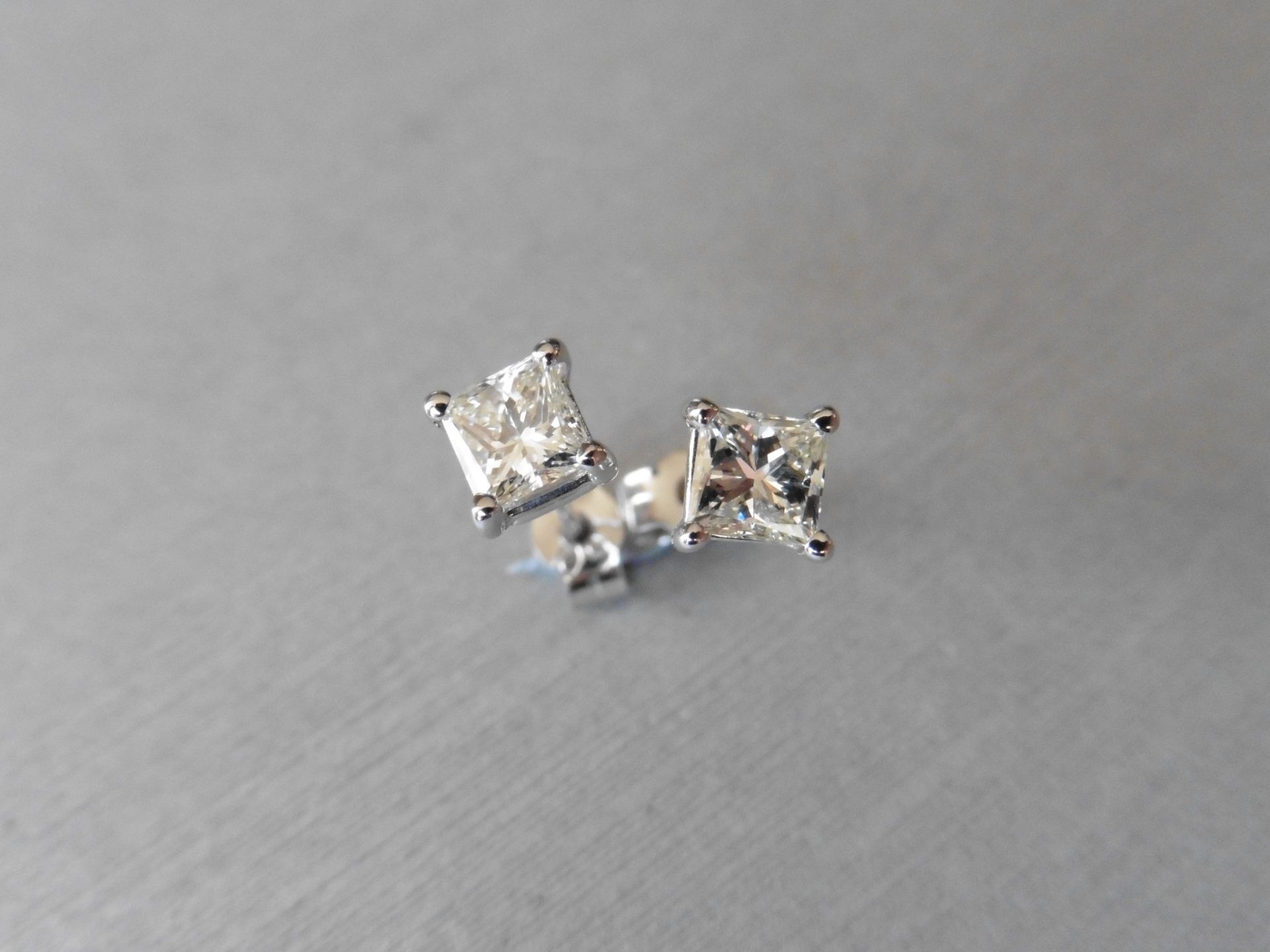 0.80ct diamond solitaire earrings. Each set with a princess cut diamond, I colour VS clarity. 4 claw