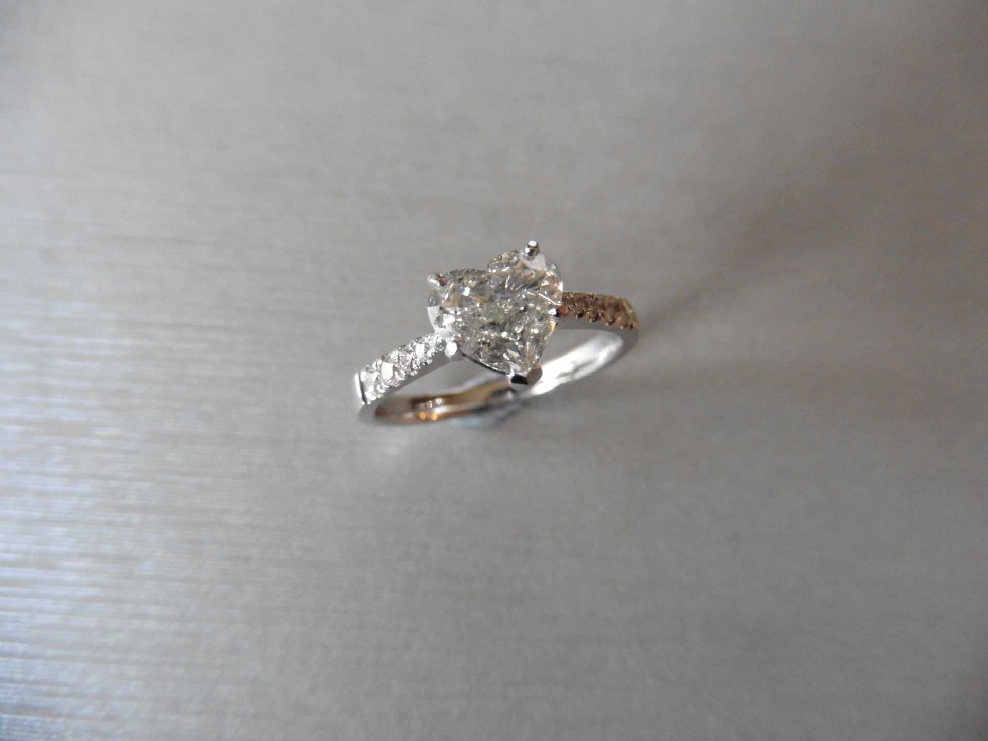 0.70ct heart shaped diamond solitaire ring J colour. The shoulders are set with 0.15ct small