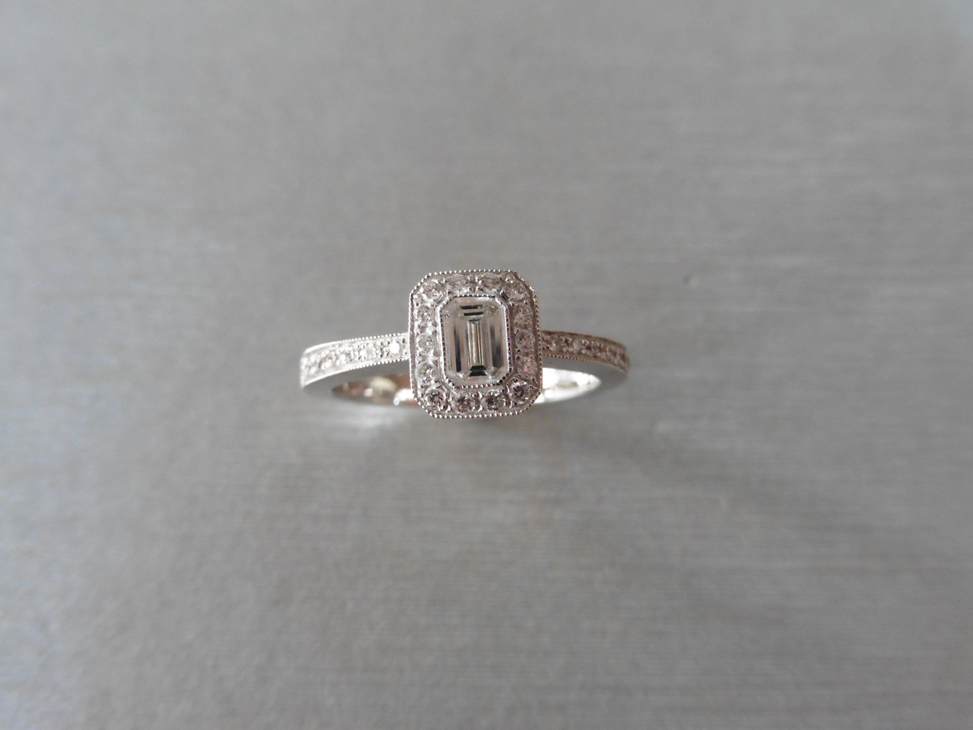 0.31ct 18ct white gold diamond set ring is set with a emerald cut diamond of VS clarity. This is set