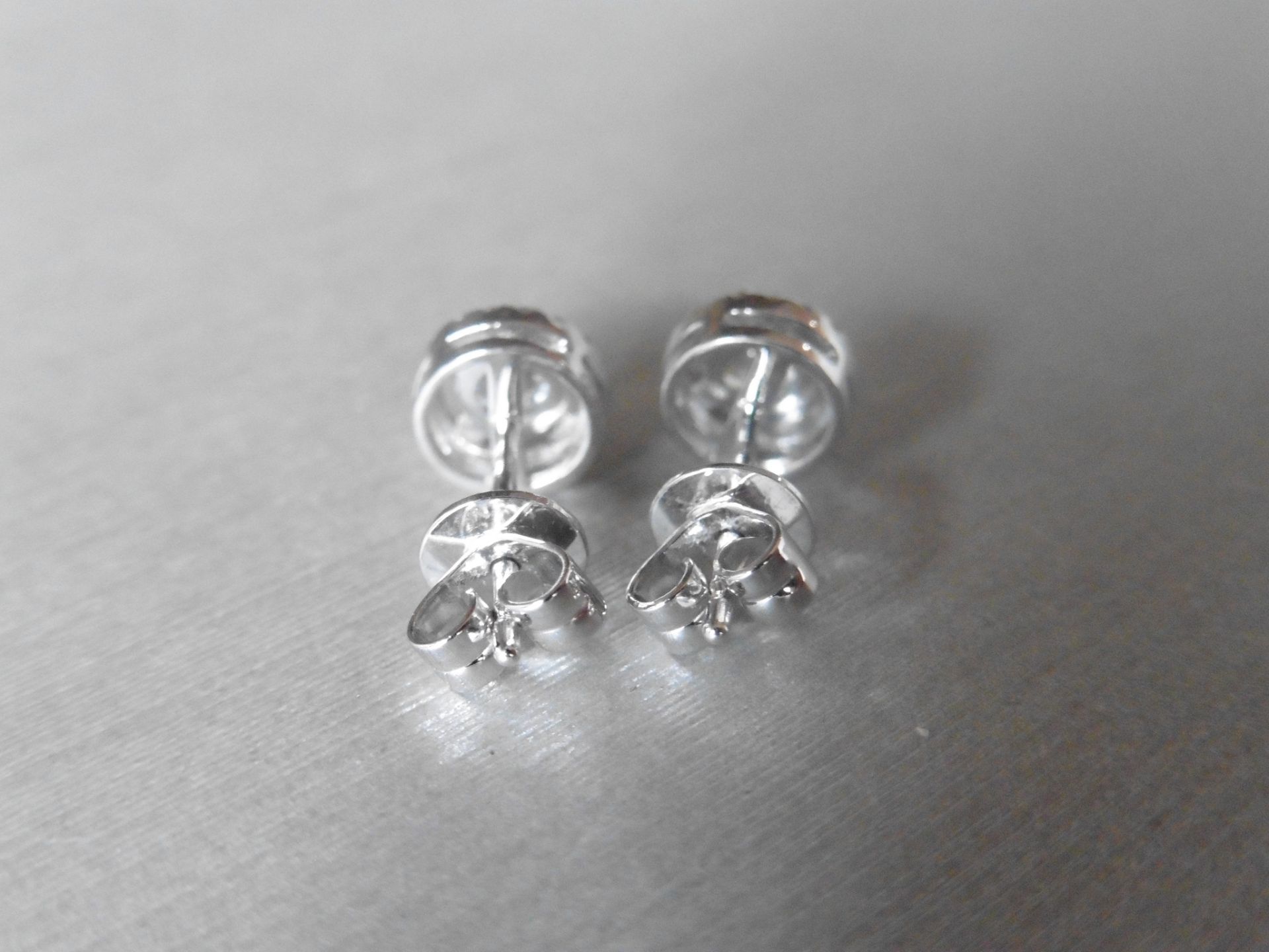 1.00ct diamond stud earrings each with a halo setting. 0.80ct total weight in the centre, H/I - Image 3 of 4