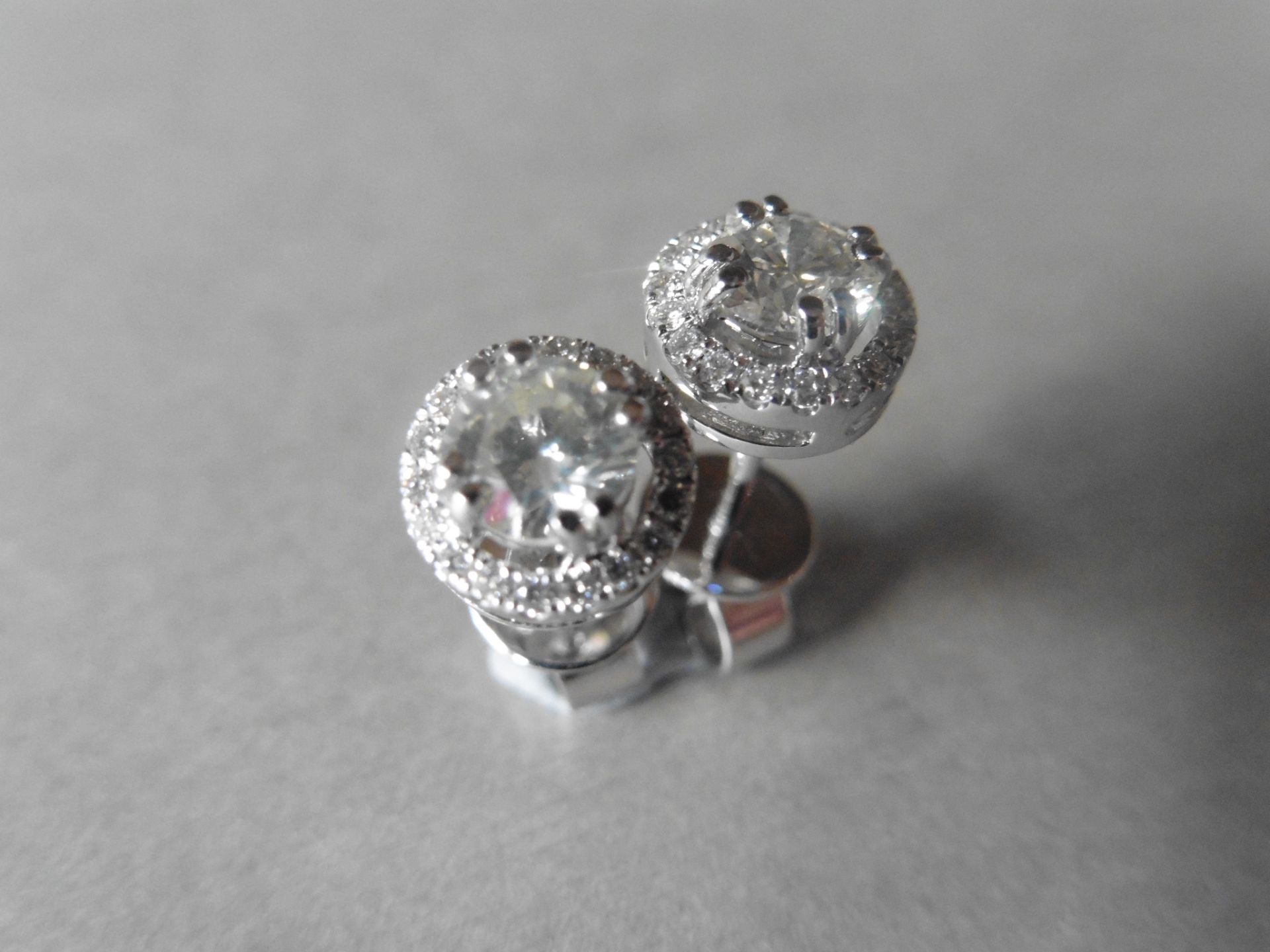 1.00ct diamond stud earrings each with a halo setting. 0.80ct total weight in the centre, H/I - Image 4 of 4