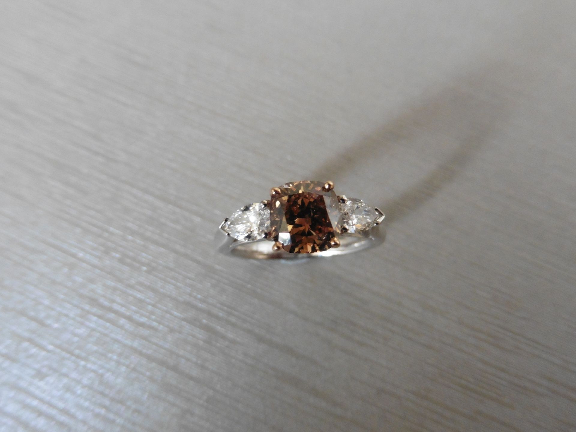 2.17ct diamond three stone ring set with a brown cushion cut diamond weighing 1.65ct, VVS2. Either - Image 4 of 4