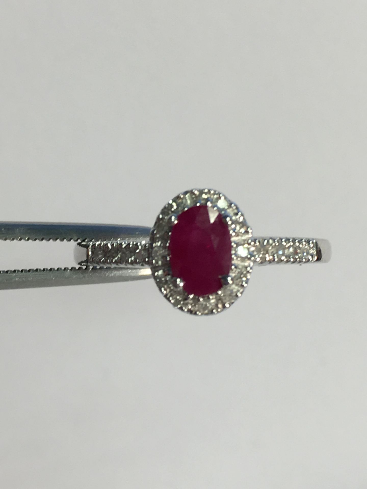 9k White gold ladies ring set with an oval Ruby and diamond surround - Image 2 of 3