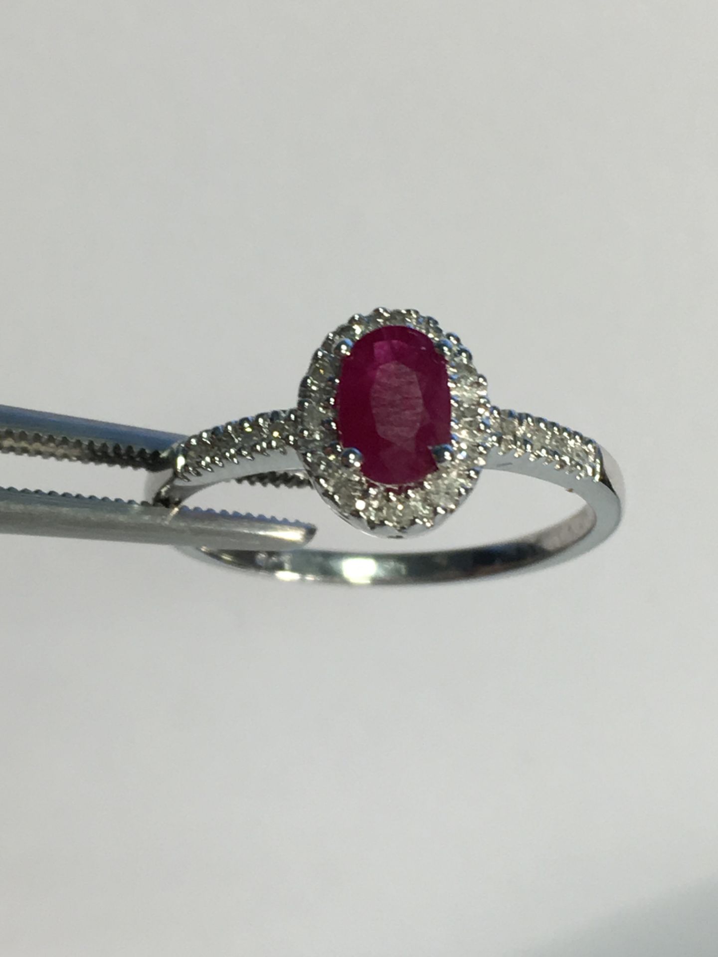 9k White gold ladies ring set with an oval Ruby and diamond surround - Image 3 of 3