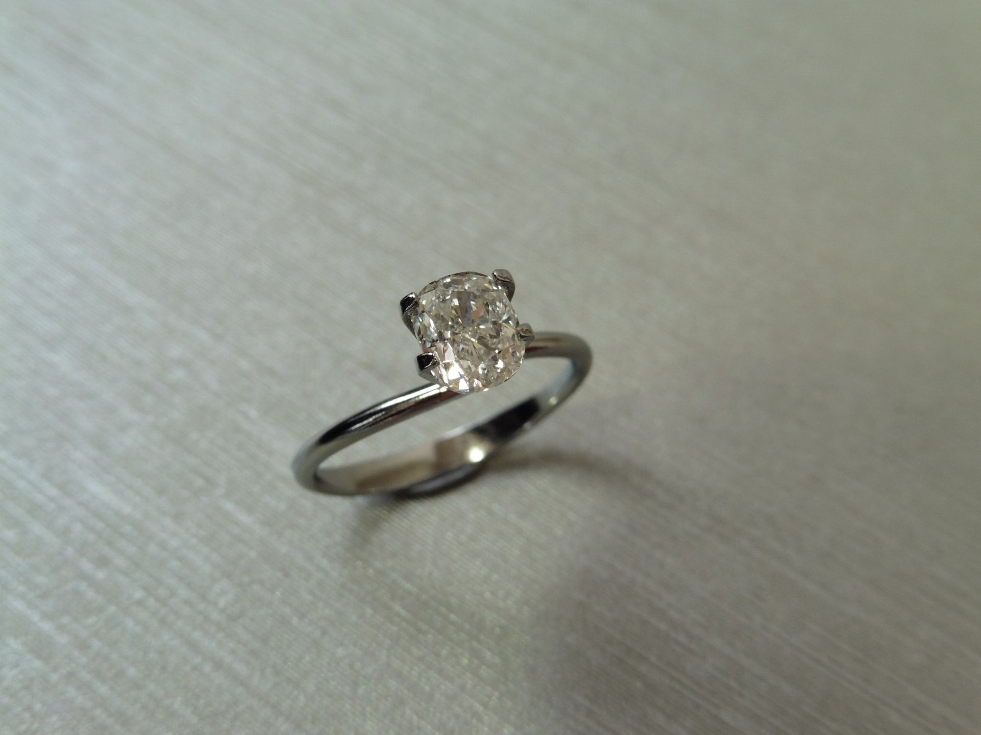 1.01ct single cushion cut diamond. Measurements 6.41 x 5.29 x 3.57mm. F colour and Si2 clarity.