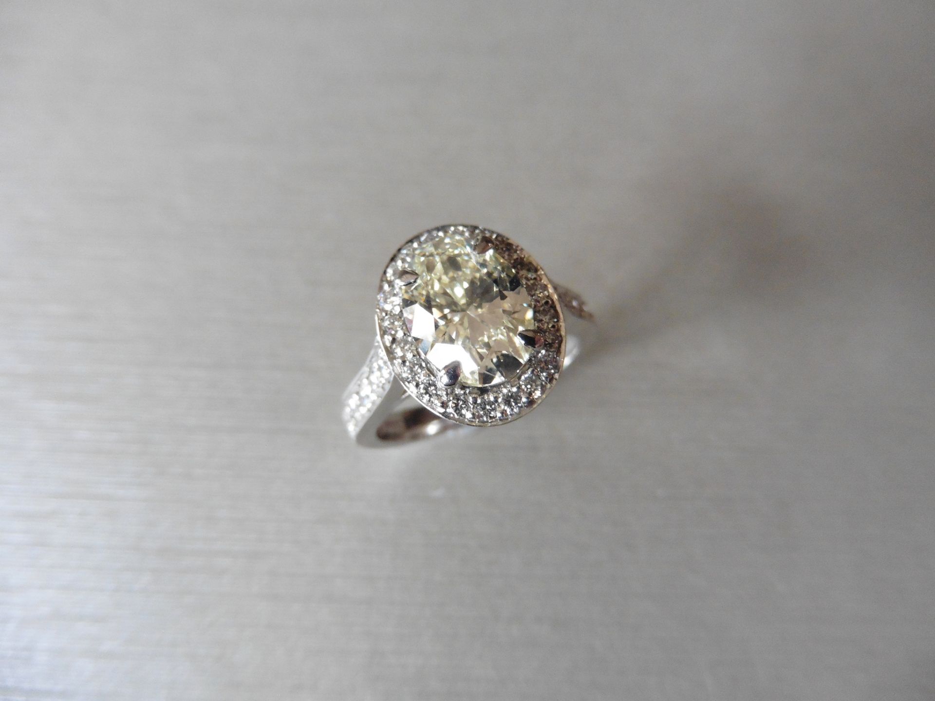 18ct white gold diamond set solitaire ring. 2.01ct oval cut natural yellow diamond in the centre VS2