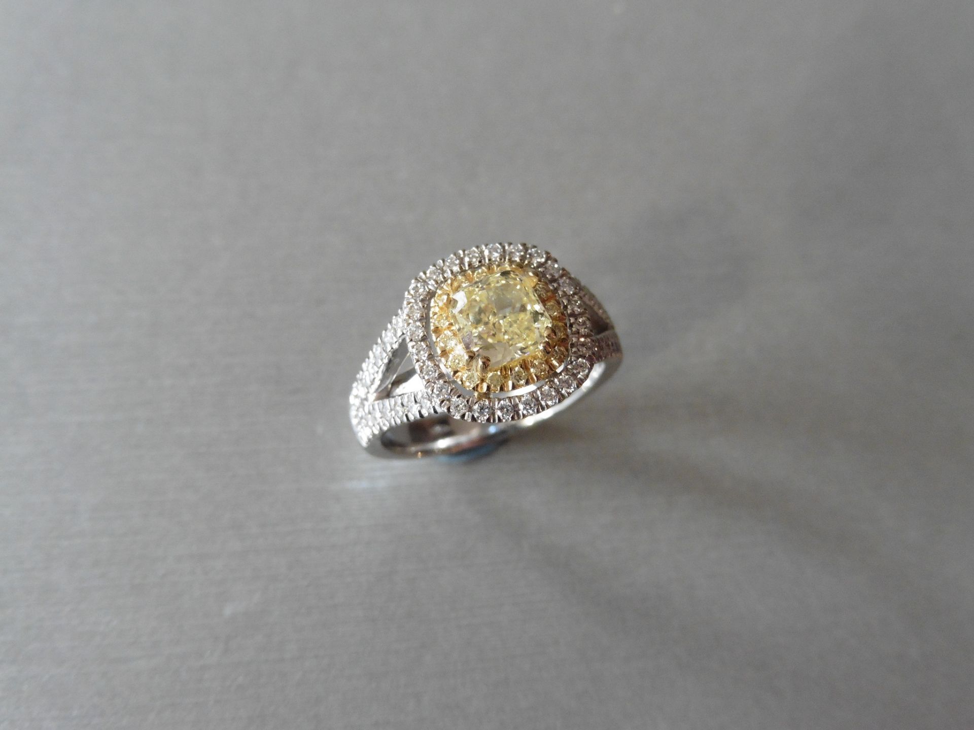 18ct white gold diamond set ring with a 1.02ct cushion cut yellow diamond, si1 clarity . It has a