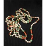 An antique pearl, coral and jade necklace with gold clasp set with six diamonds