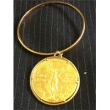 Mexican 50 peso gold coin in mount with bangle total weight is 67.6 g