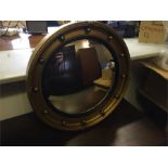 Convex mirror in gold frame