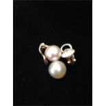 A pair of gold pearl earrings as found