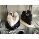 Two Franklin Mint swans on plinths. One black, one white.