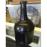 An 18th Century black glass mallet Brandy bottle