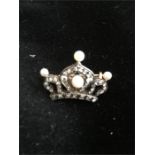 A crown shaped brooch with diamonds and seed pearls