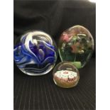 Three glass paper weights