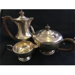 A silver teapot, hot water jug and milk jug. Hallmarked Birmingham 1931 Total weight 865 grms