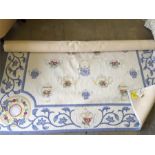 Large predominantly blue and white oriental woven rug with tags.