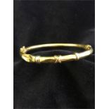 A 9ct gold bangle, some dents. 7.8g