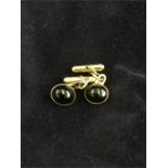 A pair of onyx and gold metal cuff links