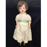 Gebr. Kuhnlenze 10 inch bisque headed doll. Sleeping blue eyes open mouth showing four teeth