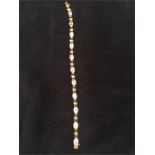 A 9ct gold bracelet with stomes