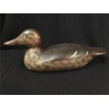 An antique wooden decoy duck