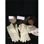A 1920's glove box with white ladies gloves