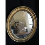 Small ornate oval gilt framed mirror