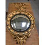 A gilt framed mirror with gilt bird