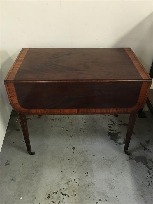 An Edwardian drop leaf table with drawer