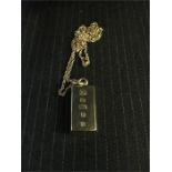 A 9ct gold ingot and chain (35g)