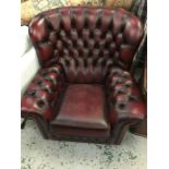A single button back leather tub chair