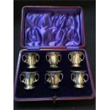 A boxed set of silver six three handled stirrup cups (121g) Hallmarked Sheffield 1910-11