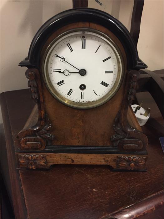 A small enamelled face mantle clock
