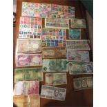 A quantity of international bank notes and colonial stamps