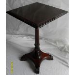 A George IV-style mahogany square-topped occasional table with fluted support on a quadruped base