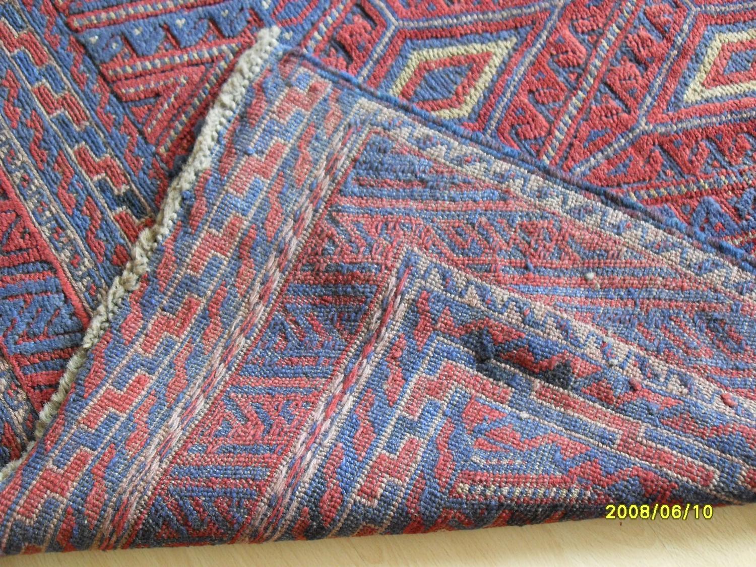 A Tajikistan hand-knotted tribal Gazak blue-ground rug with multicoloured isometric designs, - Bild 2 aus 3