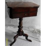 A George IV mahogany lady's work table with lift-up top, drawer under on a ring-turned support and