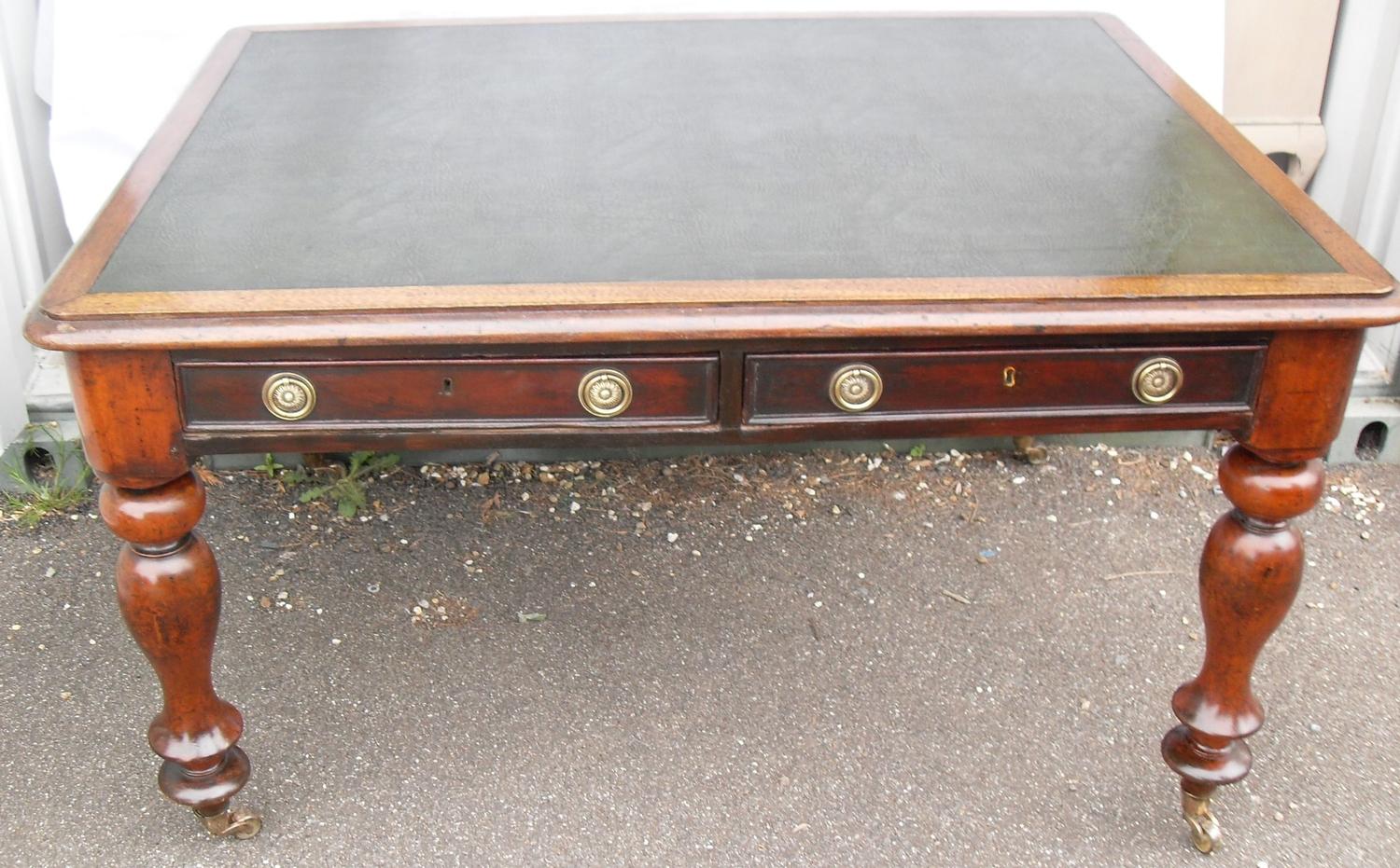 A Victorian mahogany rectangular writing table or desk with leather inset top, two frieze drawers