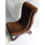A late Victorian mahogany-framed nursing chair with carved and etched designs, fabric upholstered on