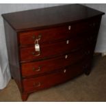 A Georgian mahogany bow-fronted chest of four graduated drawers with brass drop handles, fluted