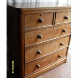 A Victorian mahogany chest of two short and three long graduated drawers on a moulded plinth and bun