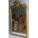 A 19th century gilt-framed console or overmantle mirror with profusely carved cornice depicting '