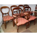 A Victorian-style set of four spoon-back dining chairs and two matching carvers with fabric