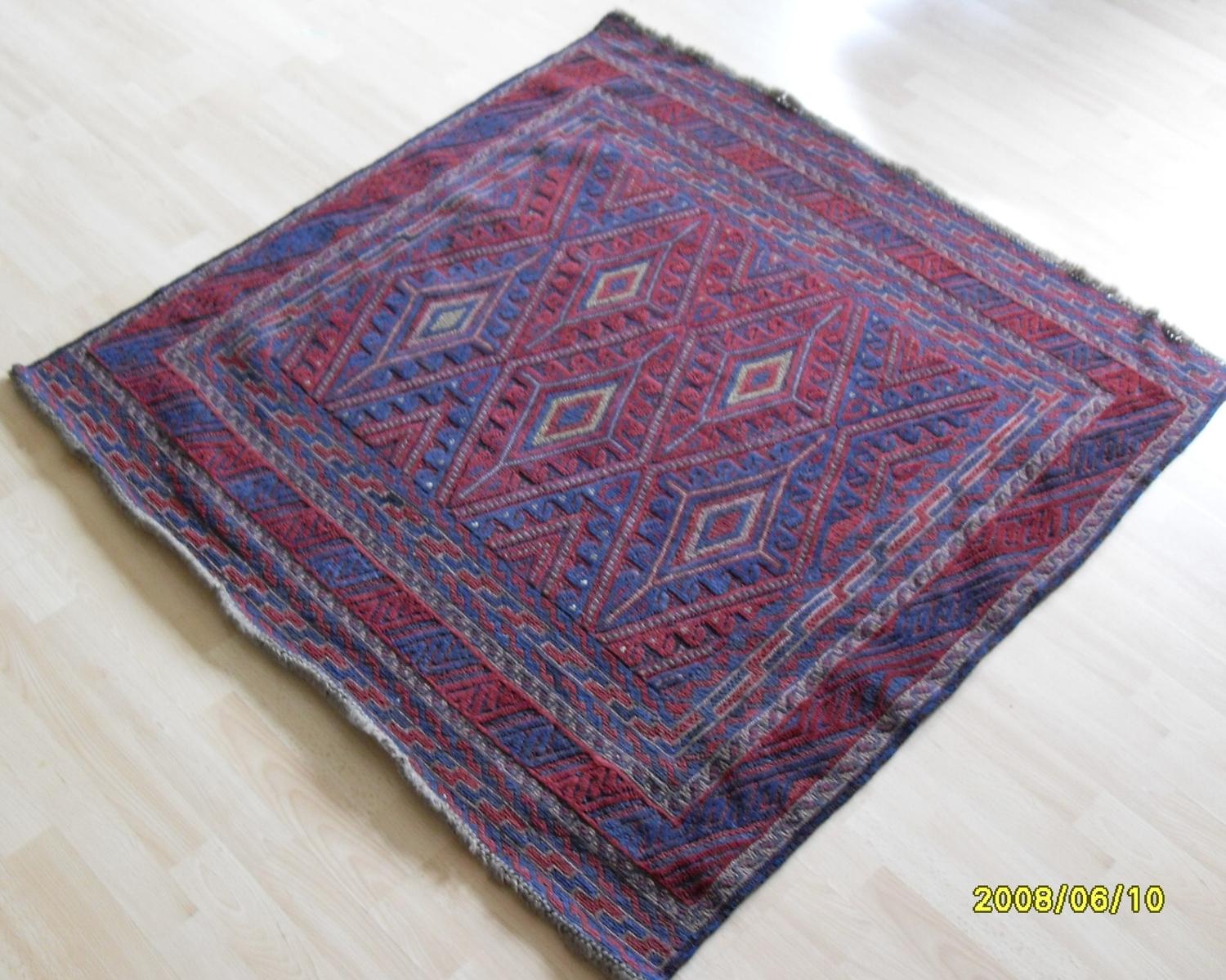 A Tajikistan hand-knotted tribal Gazak blue-ground rug with multicoloured isometric designs,
