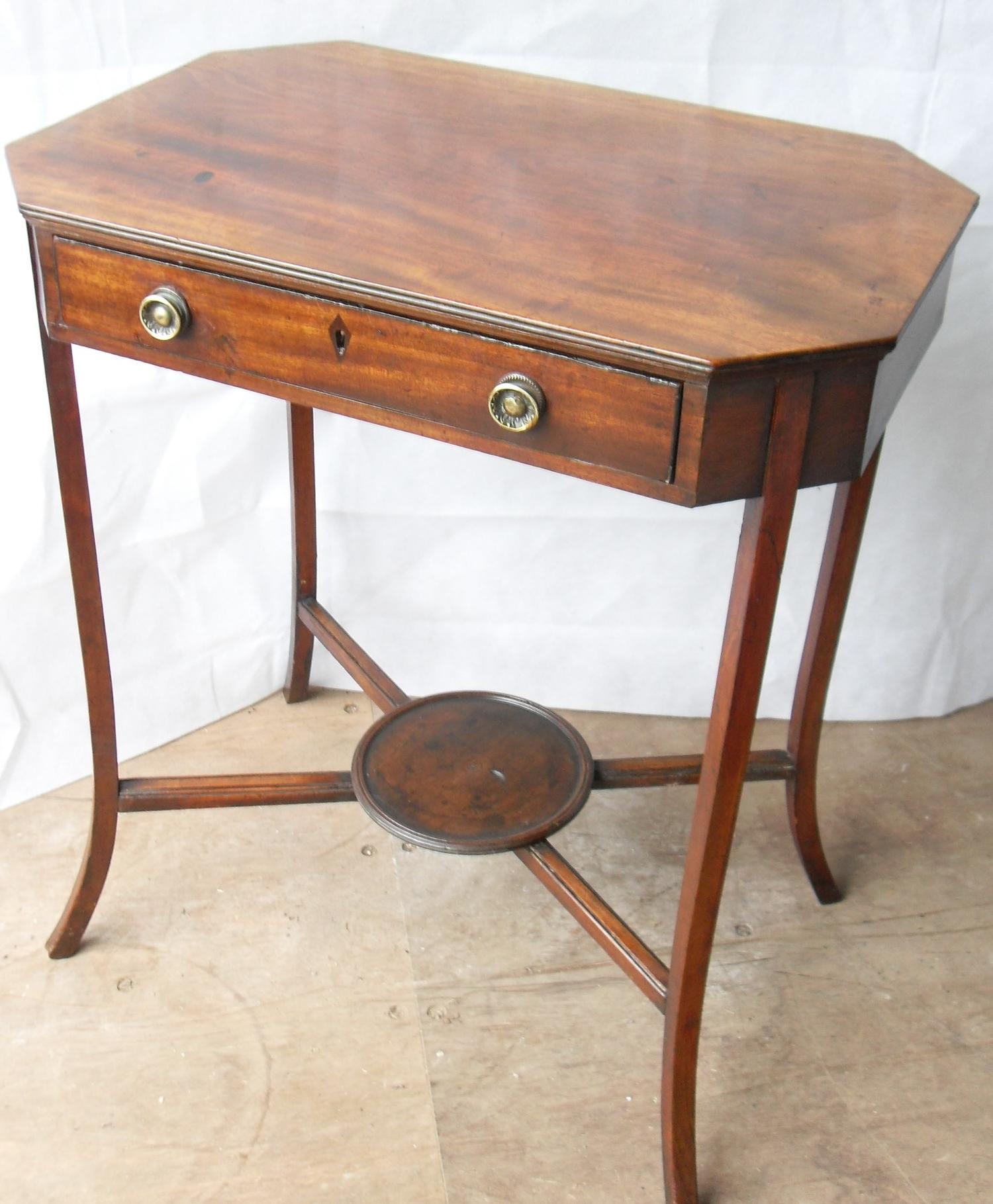 A Regency mahogany rectangular occasional table with canted corners, frieze drawer with brass drop