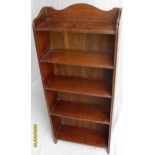 An early 20th century oak stained four-shelf free standing bookcase with channelled decoration,