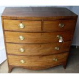 A Georgian mahogany bow-fronted chest of two short and three long graduated drawers with oval